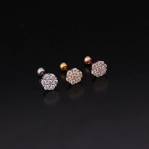 Three colors of floral stainless steel cartilage earrings with zircons on black background