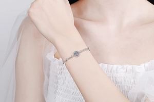Detail of S925 sterling silver moissanite bracelet on bride in white lace dress