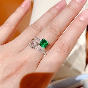 Elegant silver open ring with dual emerald cut stones and diamond paved band for women