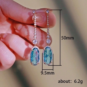 Elegant gold tassel earrings with zircon and emerald oval stones, length 50mm