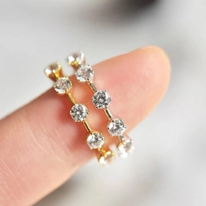 Minimalist gold and silver micro-set zircon rings stacked on finger for women