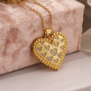 Macro shot of gold-plated heart pendant necklace with shimmering cubic zirconia stones