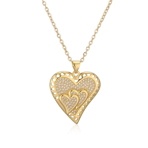 Macro shot of gold-plated hollow heart pendant necklace with shimmering zircon stones