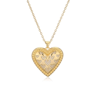Close-up of heart-shaped pendant necklace with gold plating and cubic zirconia stones
