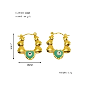Detailed size view of 18K gold plated heart earrings with green enamel eye charms