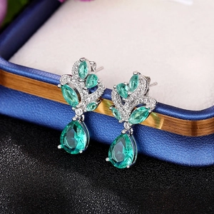 Elegant emerald pear-cut earrings with marquise leaf accents in a blue gift box