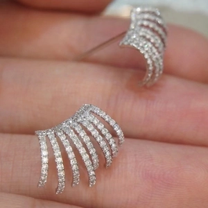 Elegant silver layered claw earrings with micro-pave cubic zirconia on model's hand