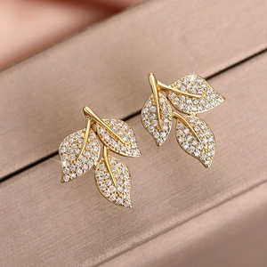 Elegant gold leaf stud earrings with sparkling cubic zirconia in a refined floral design