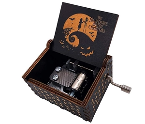 Macro view of the hand-cranked wooden music box with Nightmare Before Christmas engraving