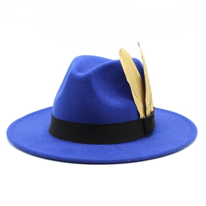 Detail of royal blue wool fedora hat with black grosgrain ribbon and golden feathers