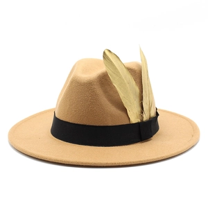 Close-up detail of a camel wool felt fedora featuring gold feathers and a black ribbon band