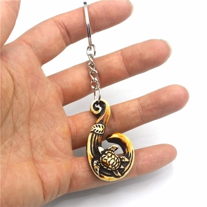 Maori style turtle and fish hook resin keychain with imitation bone finish detail