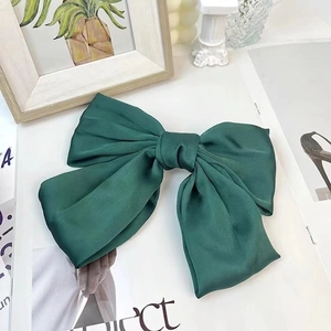 Elegant large forest green satin bow hair clip with a smooth glossy silk texture