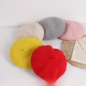 Detail view of colorful pearl-studded wool berets for girls in five vibrant colors