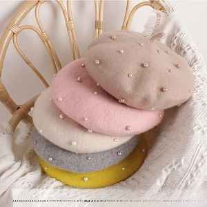 Close-up of pearl-embellished wool berets for girls in five assorted autumn colors