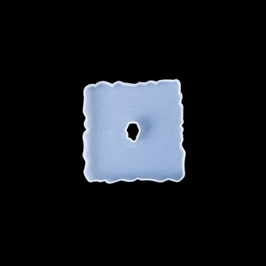 Detailed view of blue square silicone mold with irregular edges and central cutout design