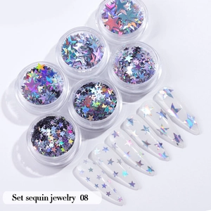 Macro detail of holographic star nail sequins set in jars with application on nail tips