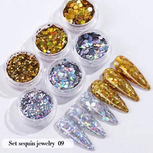 Detail view of 6-color gold nail sequin set with application on stiletto nails