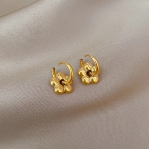 Minimalist gold flower hoop earrings in titanium steel on a premium silk background