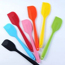 Set of eight colorful silicone spatulas arranged in a fan shape for baking and cooking