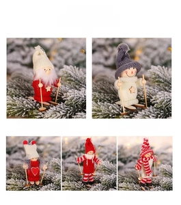 Detailed view of assorted wooden Christmas ski figurines with knitted outfits and ski poles