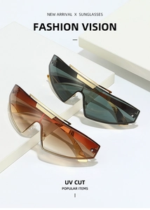 Detail of futuristic rimless sunglasses with gradient lenses and gold metal top bar