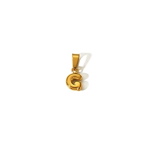 Detailed view of a golden bubble letter G pendant made of 18k gold-plated stainless steel