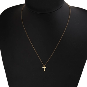 Polished minimalist gold cross pendant necklace on black neck display for men and women