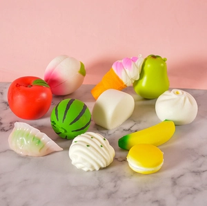 Macro shot of 10 colorful PVC slow-rebound squishy food toys including fruits and sweets