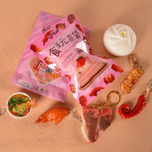 Detail of realistic PVC miniature food charms including noodles and steak in blind bags