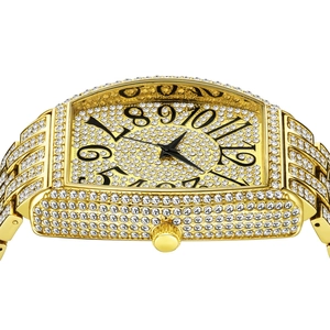 Detail of tonneau-shaped gold watch with crystal encrusted dial and black numerals