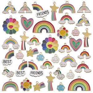 Colorful enamel DIY charms including rainbow, sun, and hearts on a white background