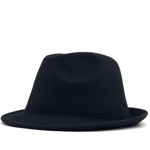 Detail of a vintage black wool fedora featuring a classic pinch front and narrow brim