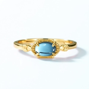 Vintage gold S925 silver ring featuring a blue rectangular gemstone on white background