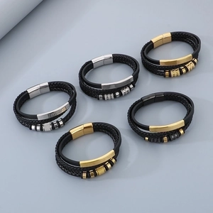 Detailed view of woven leather bracelets with gold, silver, and black magnetic clasps
