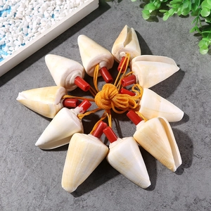 Handcrafted conical white shell whistles with red stoppers and yellow cord strands