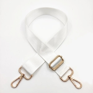 Detail of adjustable white nylon strap with gold metal hooks for shoulder bags