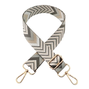 Close-up of arrow pattern woven wide bag strap with gold metal swivel lobster clasps