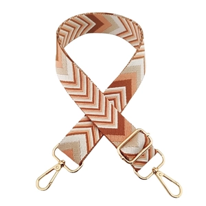 Close-up of chevron woven wide strap with gold metal lobster clasps and buckle