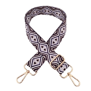 Detail of adjustable geometric diamond weave strap with gold metal spring hooks