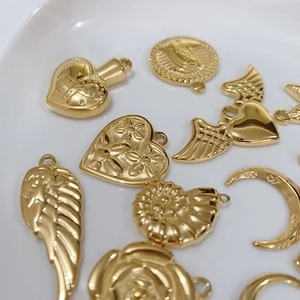 Golden titanium steel charms in heart, wing and coin shapes for DIY jewelry making