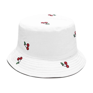 Detailed view of white canvas bucket hat featuring red and green cherry embroidery patterns