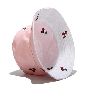 Detail view of pink bucket hat with cherry embroidery and double-sided cotton fabric