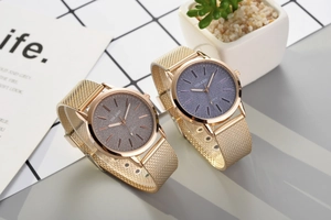 Macro detail of luxury gold quartz watch dial with shimmering starry sky star pattern