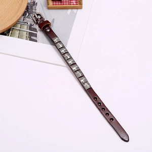 Detail of brown leather punk bracelet with silver square studs and buckle closure