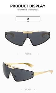 Close-up of futuristic punk frameless sunglasses with gold metallic frame and C1 gray lens