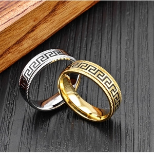 Detail of 8mm wide stainless steel rings featuring Greek key pattern and ridged edges