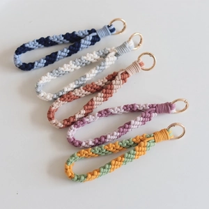 Five handmade macrame wristlet keychains with striped texture and gold rings