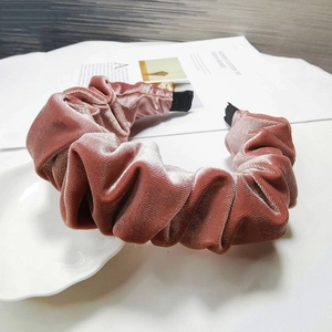 Detail of dusty pink velvet pleated headband with soft texture and professional finish
