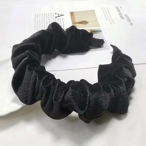 Macro detail of high-quality pleated black velvet headband texture and soft fabric finish